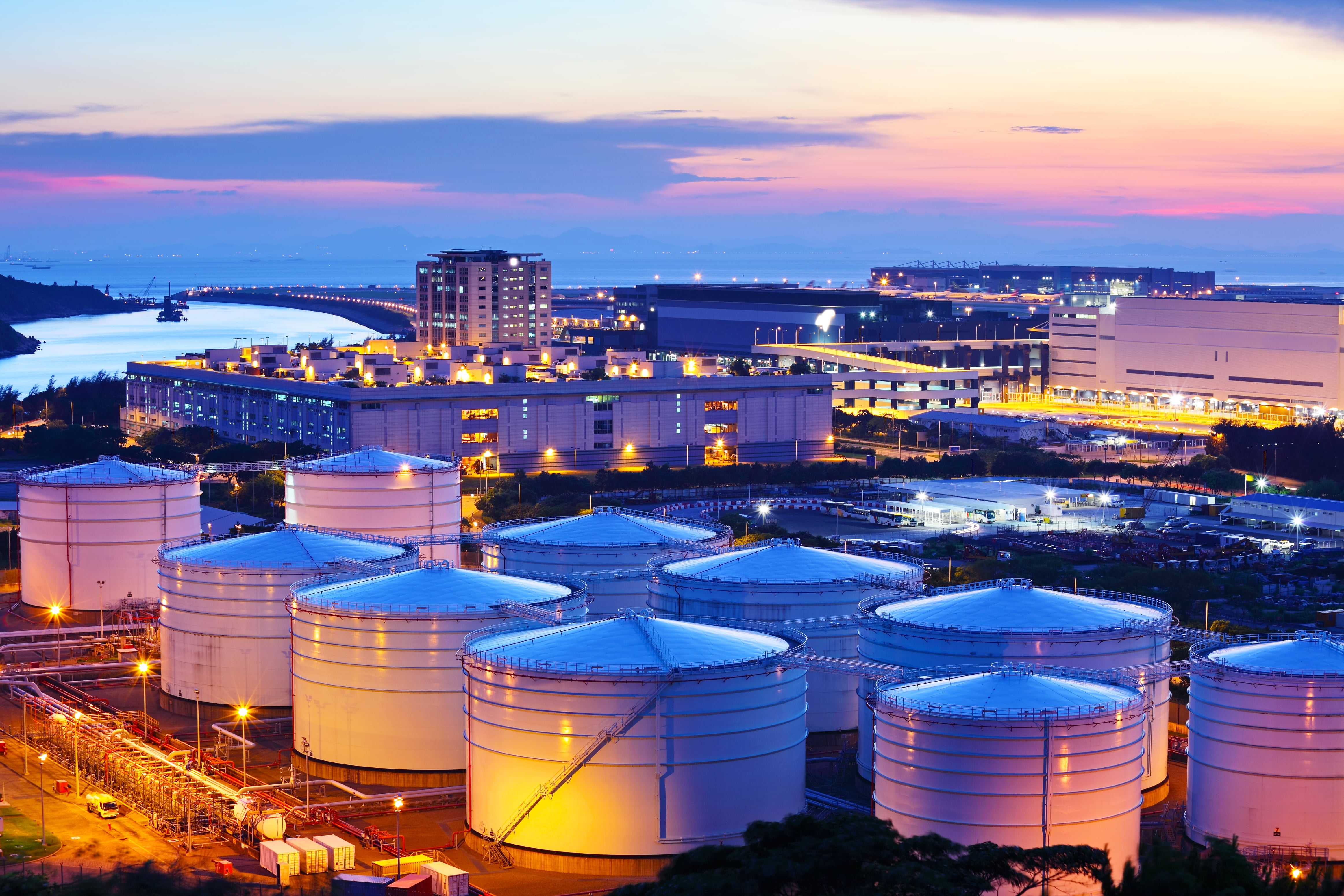 Oil and gas processing facility illuminated at dusk